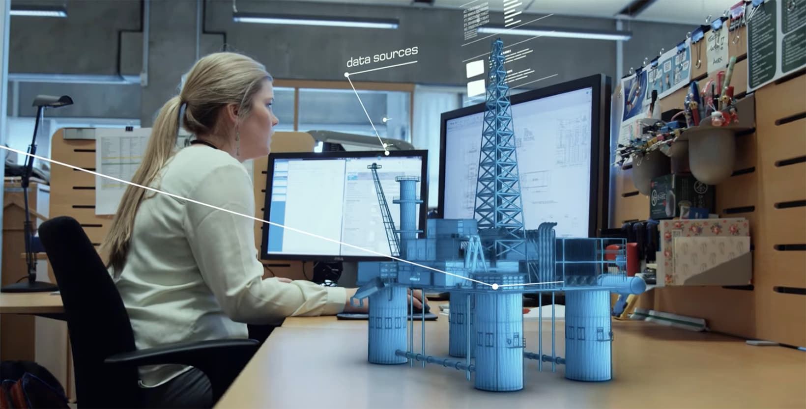 Female Engineer at her desk working with digital twin