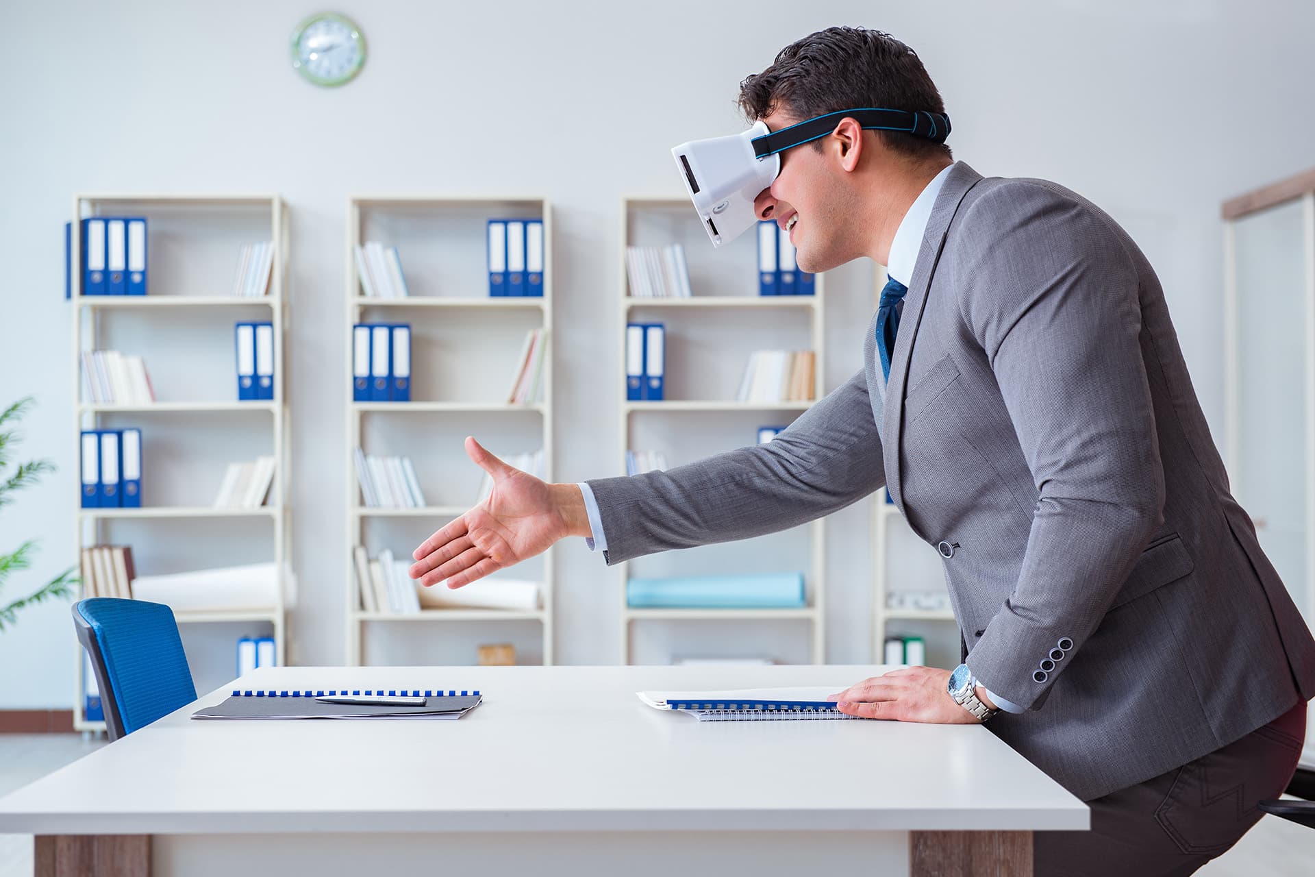 real estate agent handshakes with client in virtual meeting