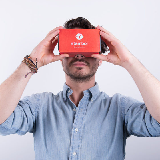 male model holding Google Cardboard with Stambol logo