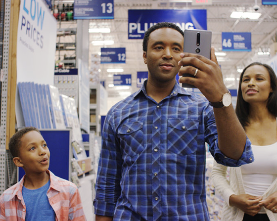 young couple with a kid in retail store checking AR app