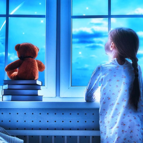 Girl making a wish by seeing a shooting star at bedtime night