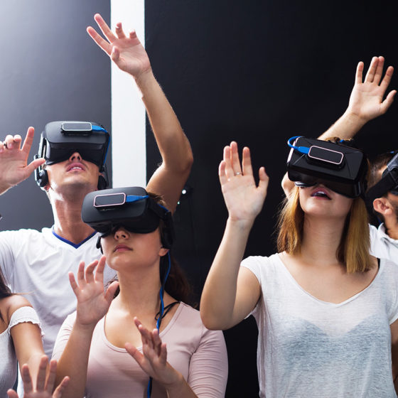 group of young people immersed into virtual reality experience