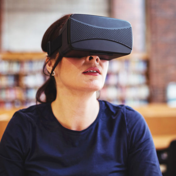 Mature student using virtual reality headset in public library