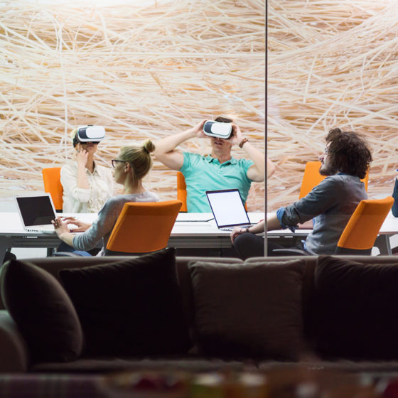 startup business team using virtual reality headset in a boardroom setup