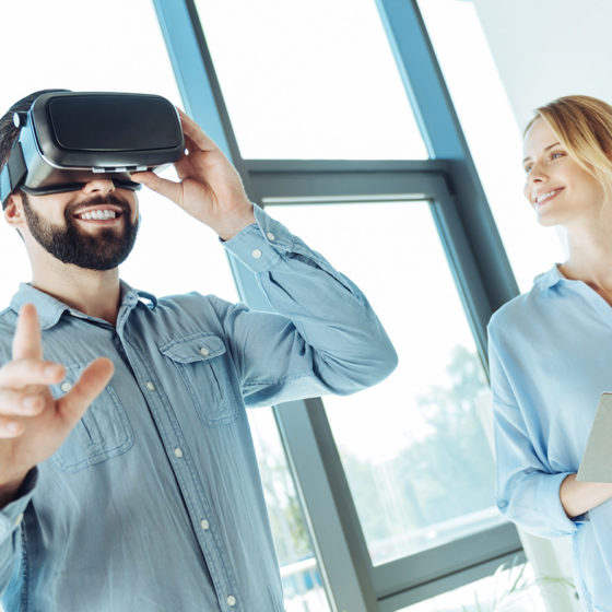 Young man trying out new VR headset in the office