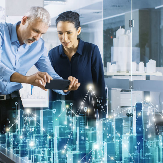 Male and Female Architects Work with Holographic Augmented Reality 3D City Model