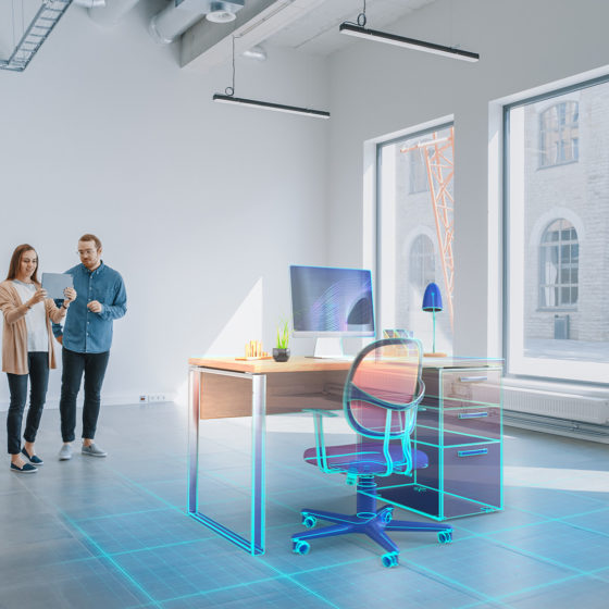 Couple using augmented reality to shop for furniture for their home office