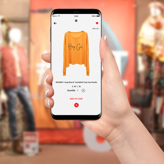 Woman in front of store buying from the mobile retail shop online.